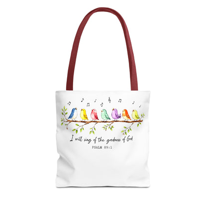 A white canvas tote bag with dark red handles, featuring a watercolor illustration of colorful birds sitting on a branch with musical notes and the text 'I will sing of the goodness of God PSALM 89:1'.